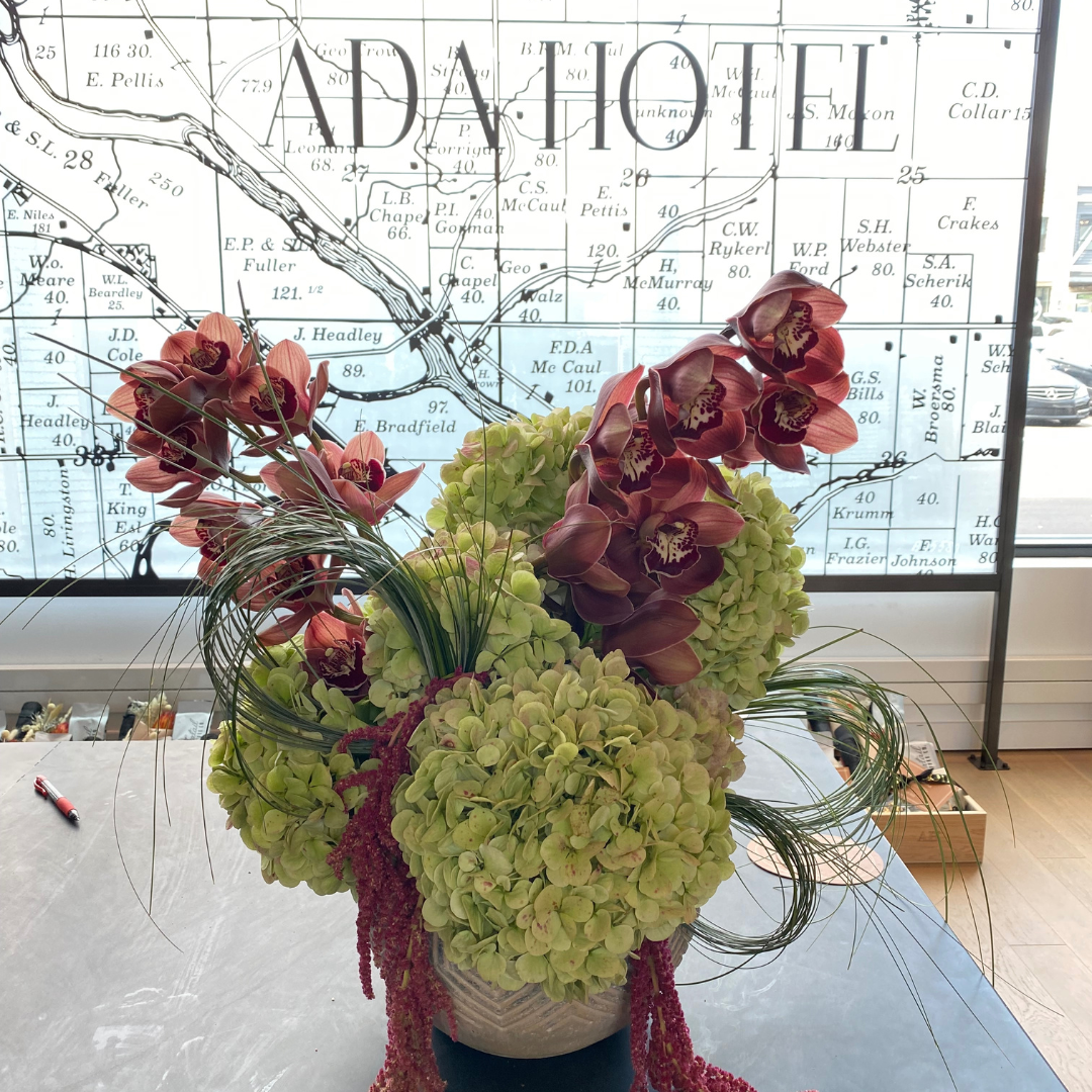 Large flower arrangement at the Ada Hotel's front desk. Hydrangea and orchids with grass and amaranthus.